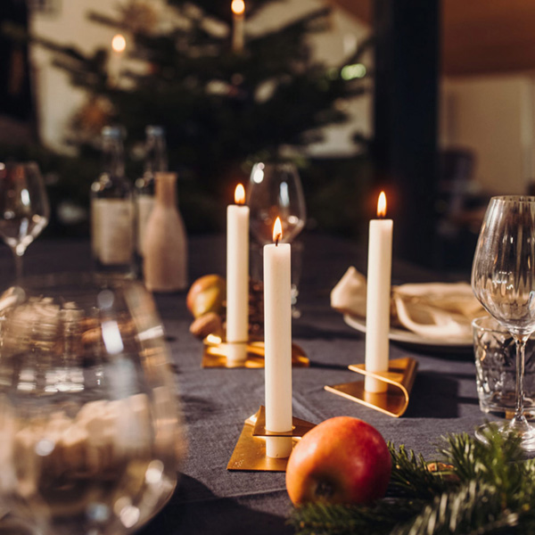 Elegant candleholders and decorative table fire on a festive Christmas dinner table