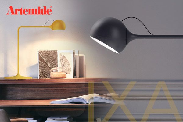 Artemide IXA LED table lamp in yellow and black in a cozy reading corner